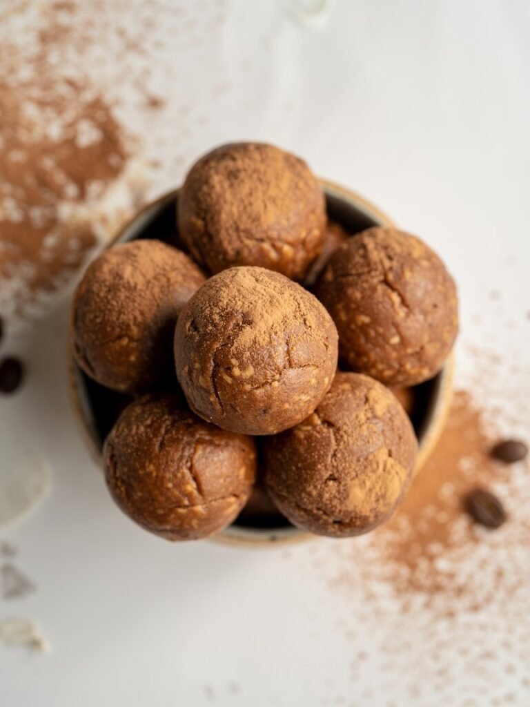 "Top-down view of mocha pumpkin protein balls with cocoa and coffee, vegan, gluten-free, healthy energy snack."